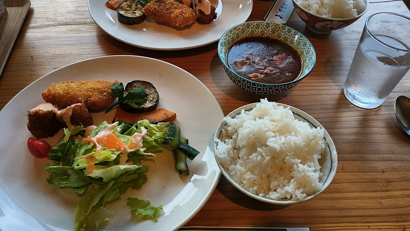 Salad, fried fish, fried ham, eggplant, curry soup, and rice