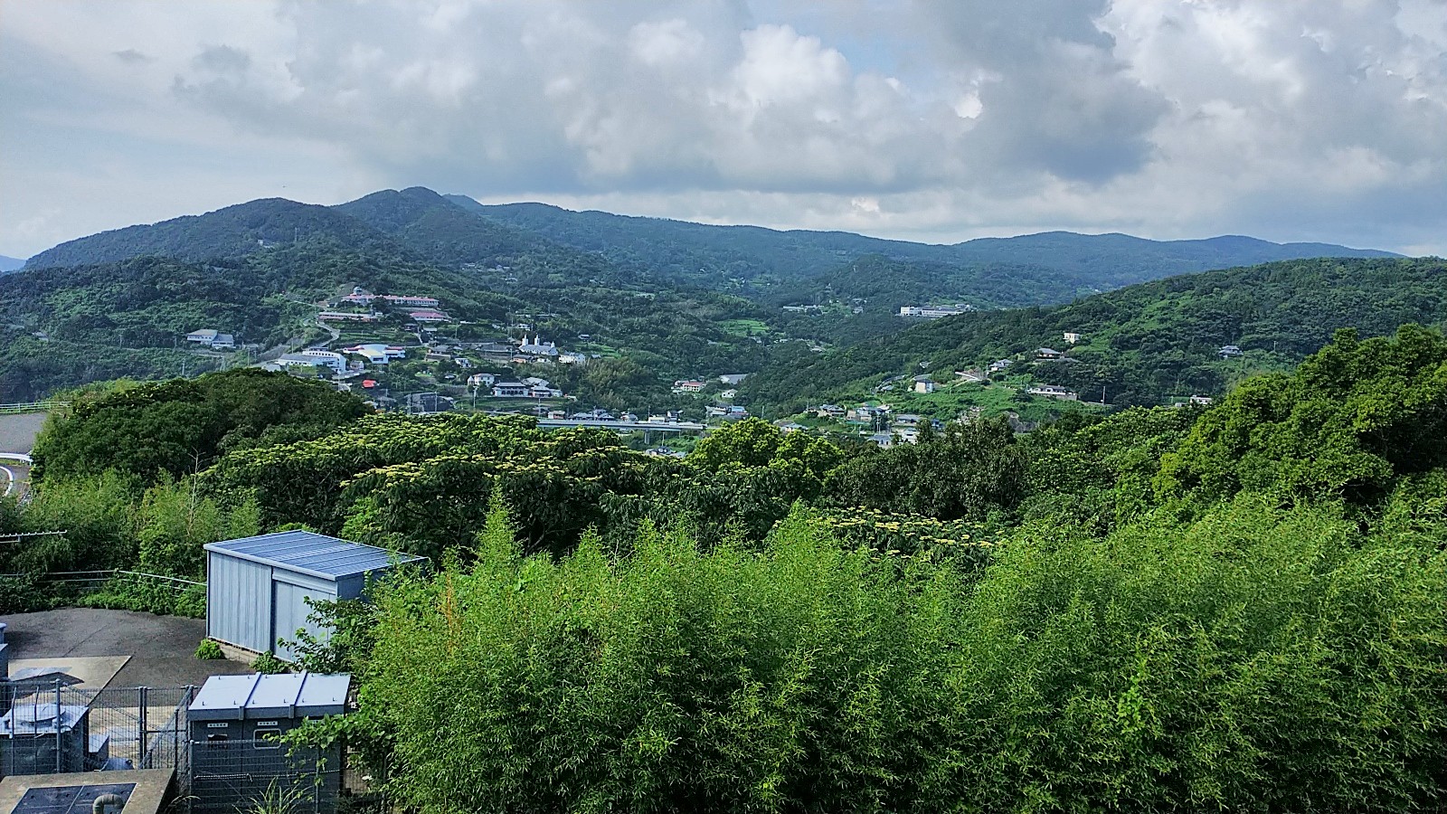 Japanese countryside with buildings scattered amongst the hills